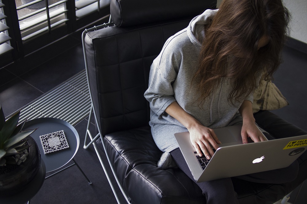 woman working on laptop in apartment