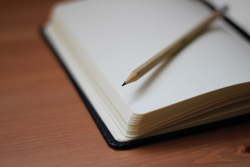 closeup-of-notebook-and-pencil